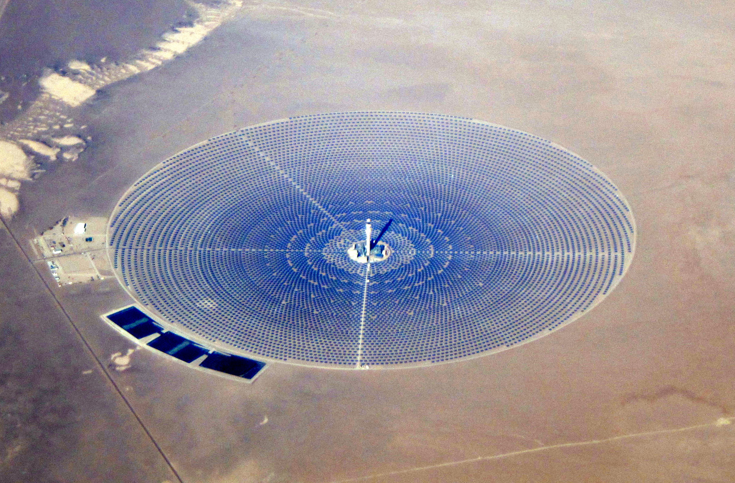 Aerial view of the Crescent Dunes concentrated solar power tower surrounded by its heliostat mirror field